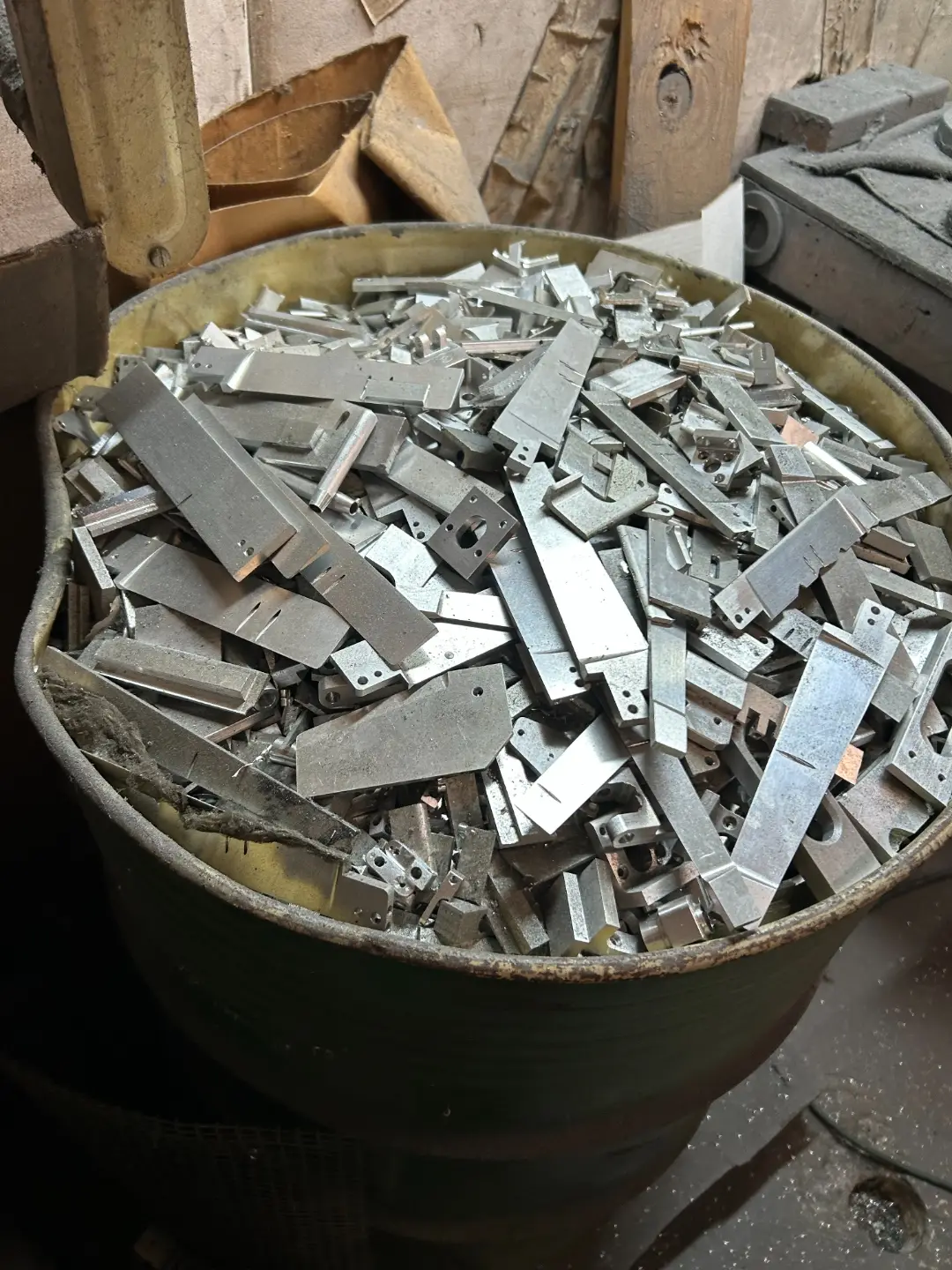 Drum filled with cut aluminum parts
