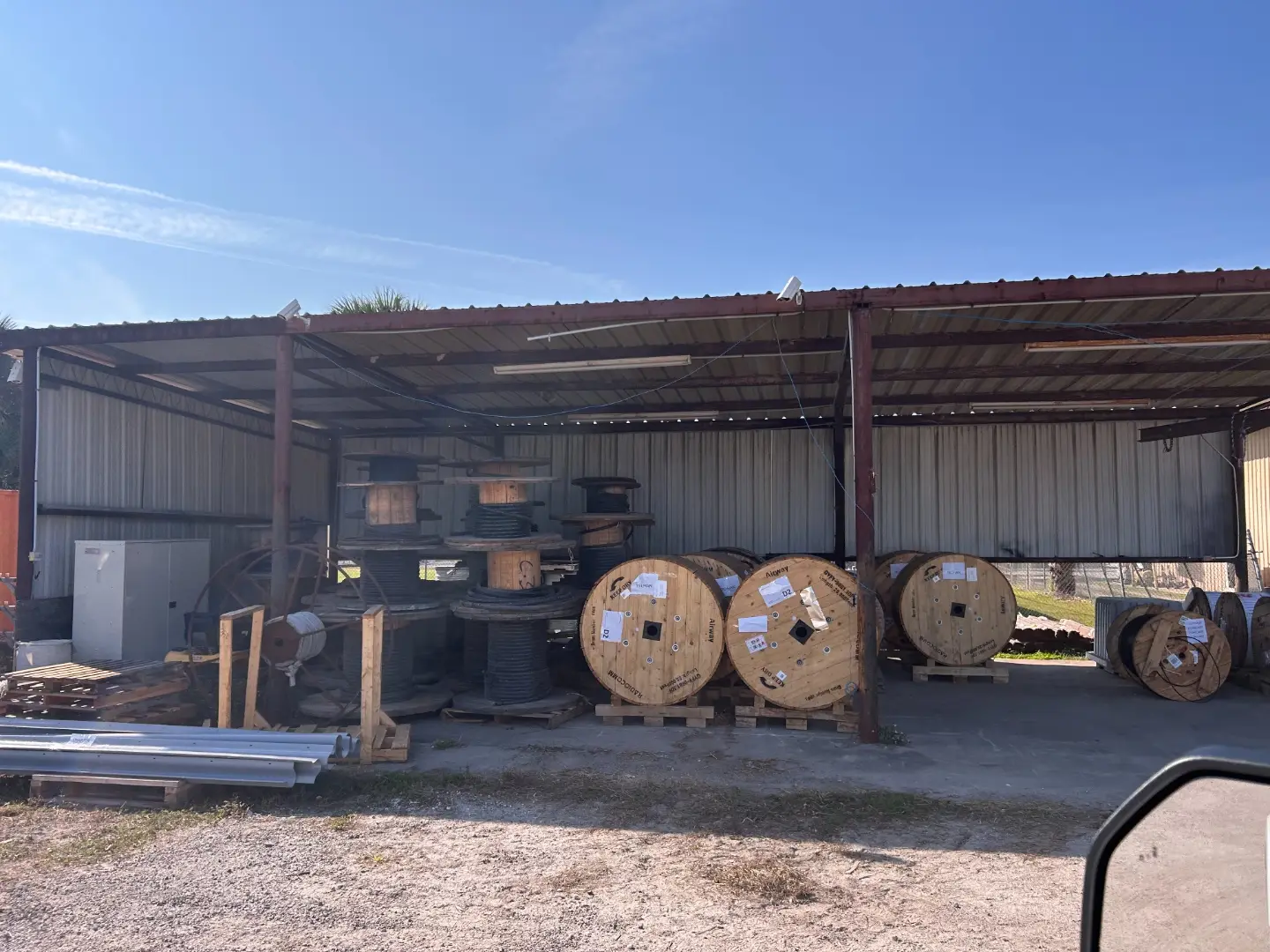 Cable reels stored under a covered yard shed