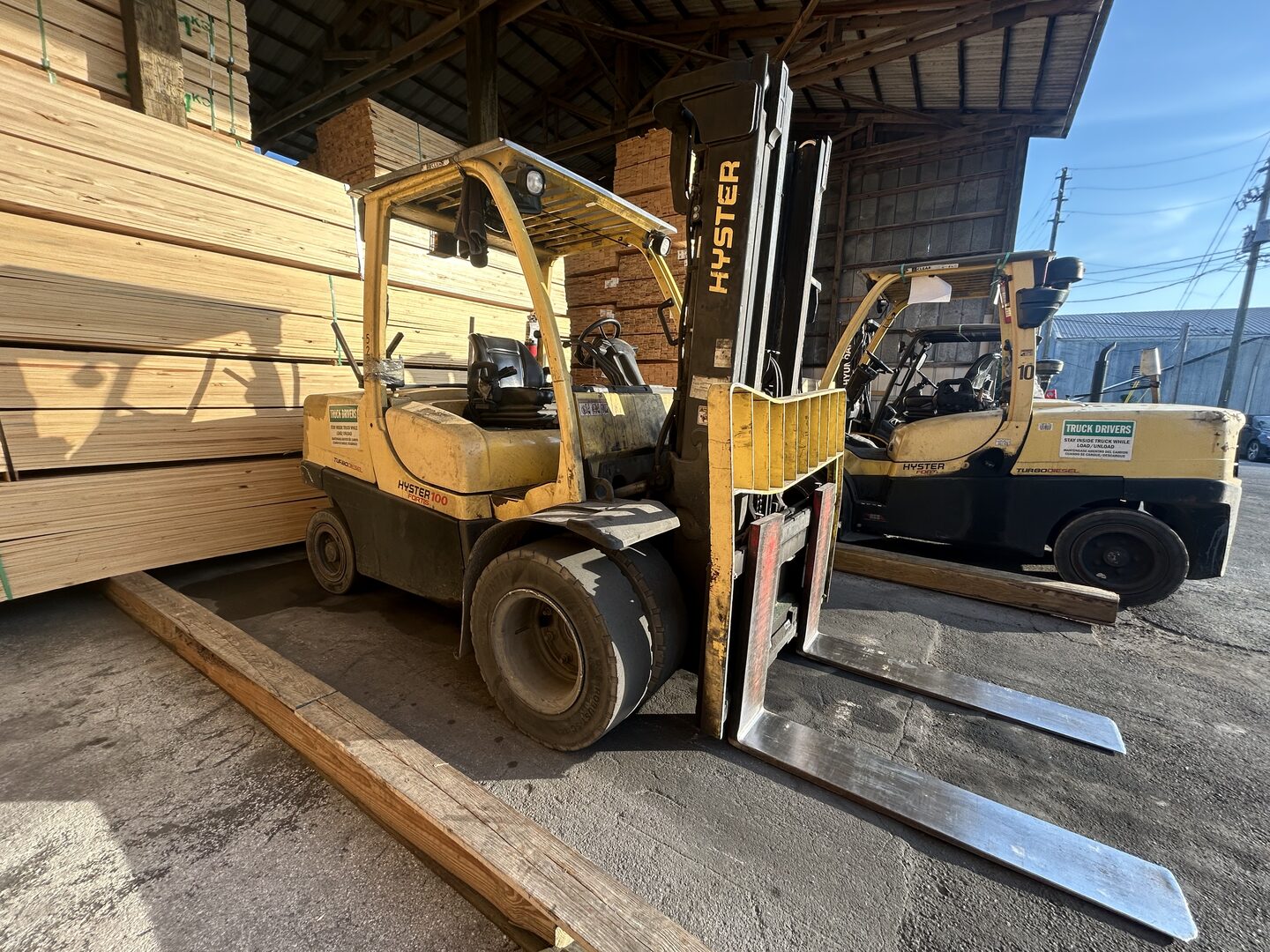 Yellow Hyster forklift moving lumber at a Central Florida jobsite