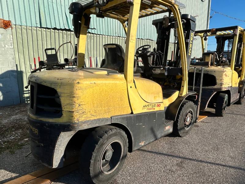 Row of forklifts in an equipment yard, purchased from a Florida seller