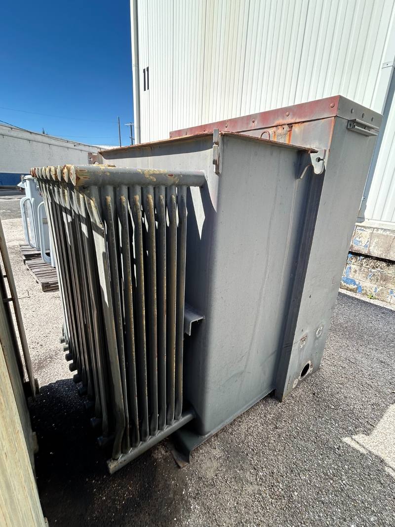 Gray liquid-filled power transformer with radiator fins, purchased in Florida