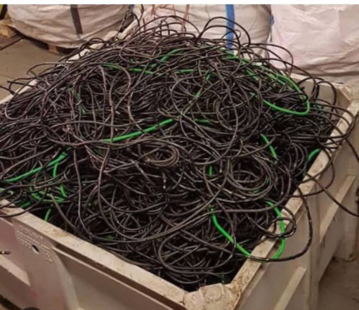 Bin full of black and green insulated wire pulled from a jobsite
