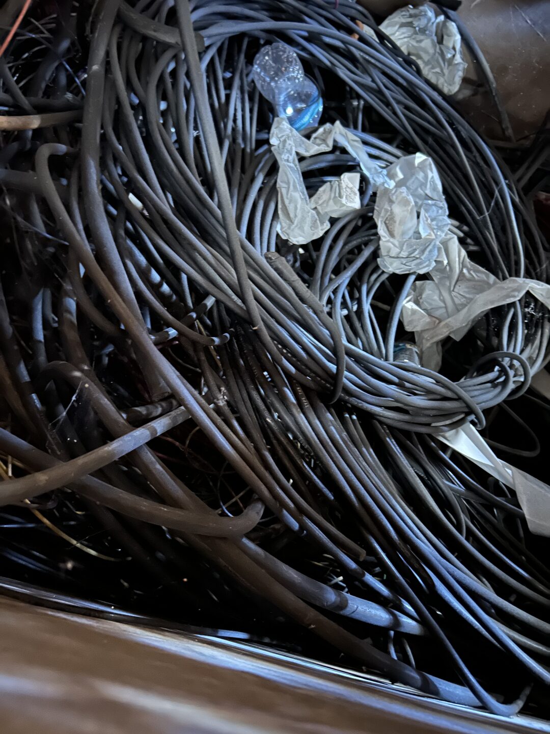 Pile of coiled black insulated wire and cable