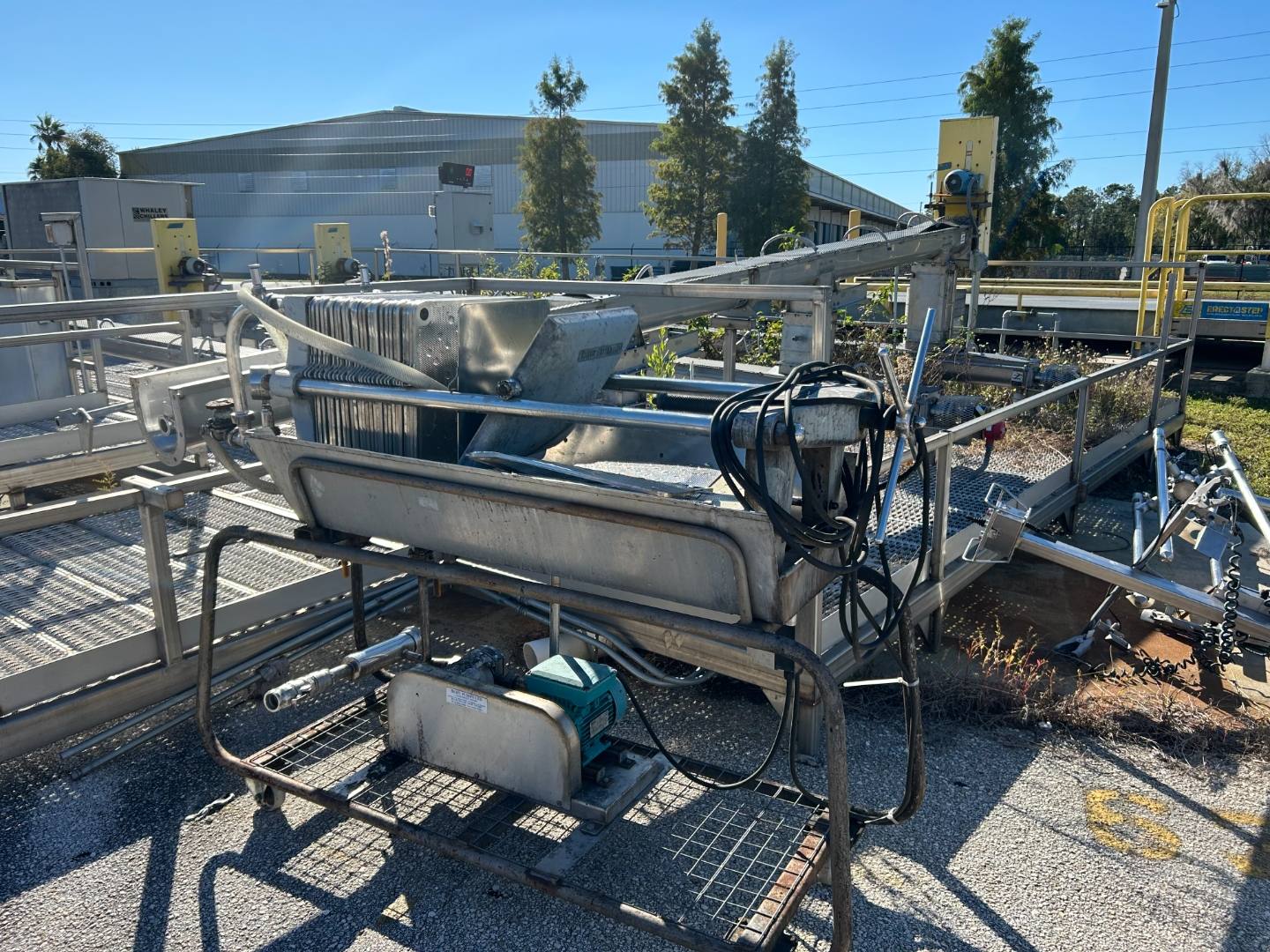 Outdoor industrial process area with equipment and walkways